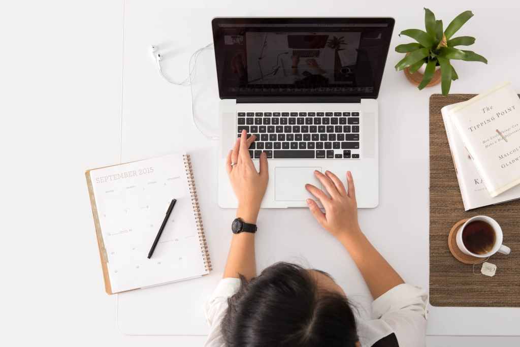 Woman working at laptop with clear desk space