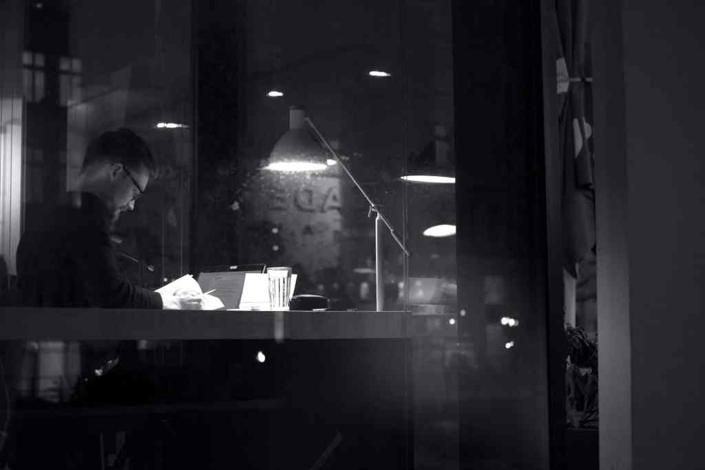 Man studying late at night in a cafe