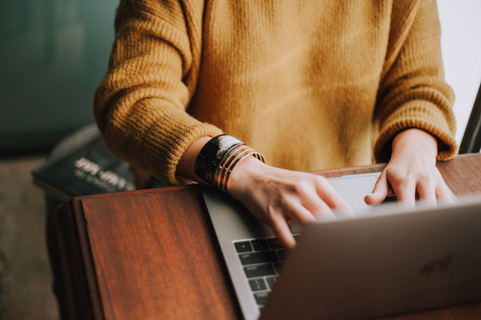 Woman writing on a laptop