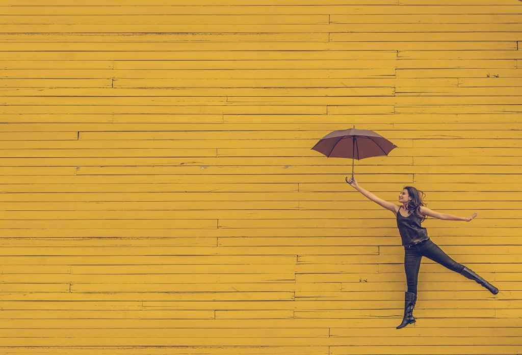 woman looking happy jumping