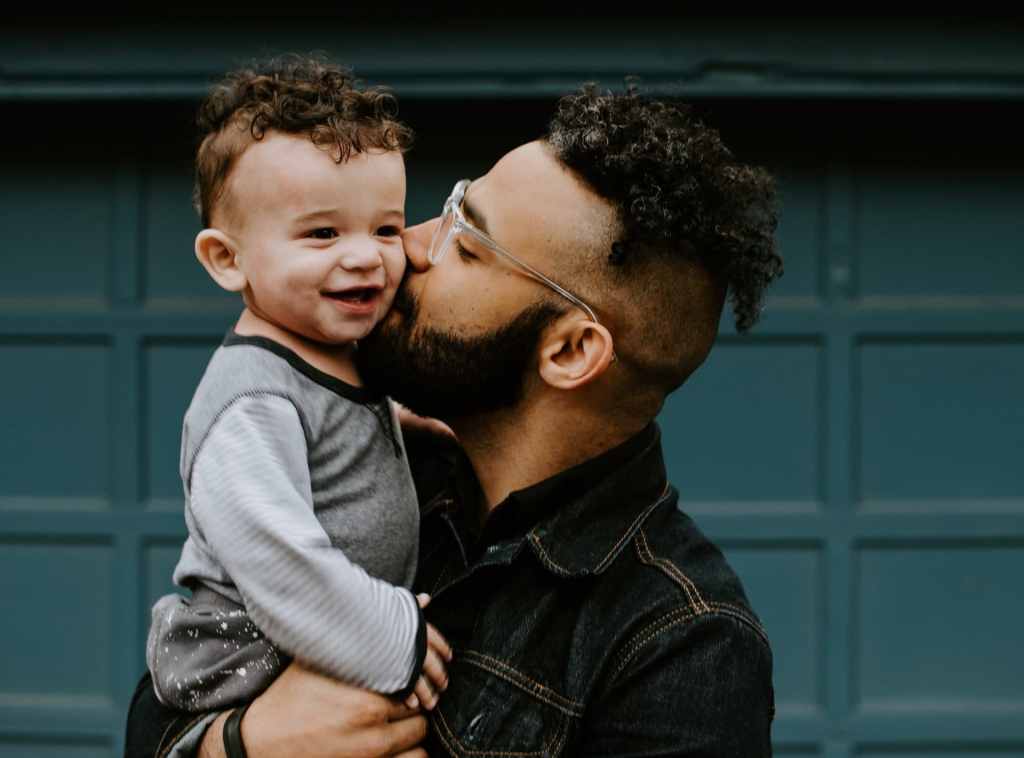 Dad kissing his baby son