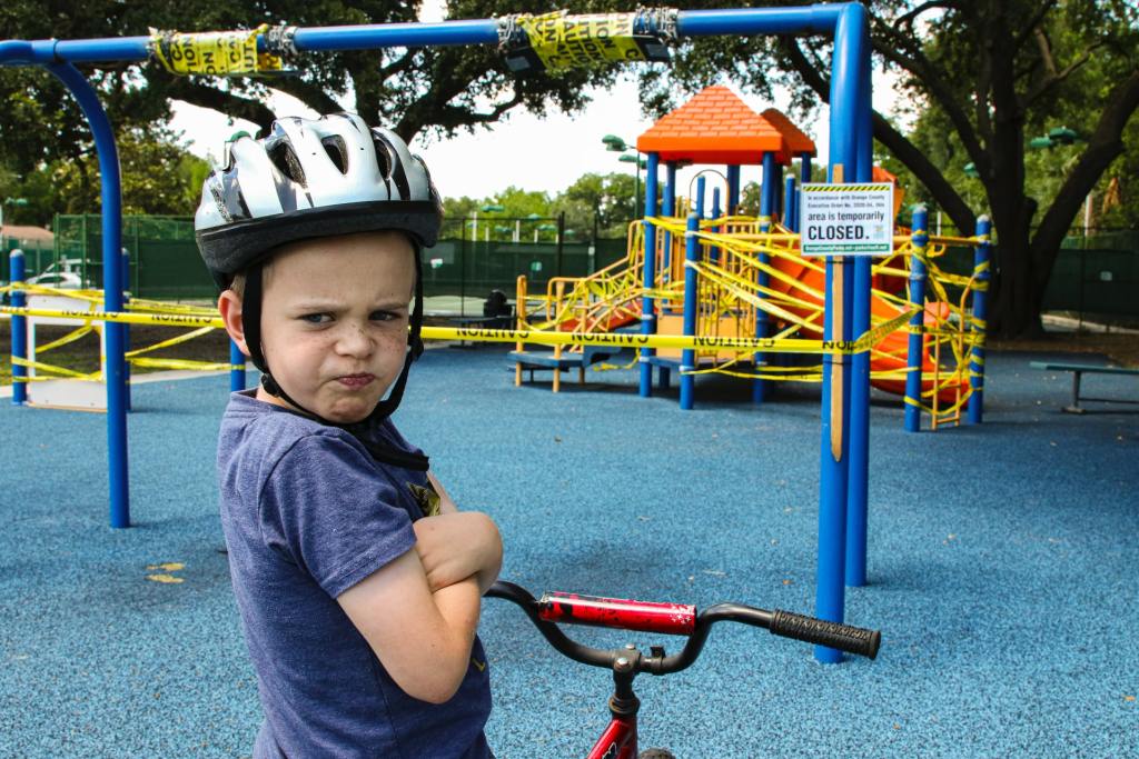 Boy on playground looking annoyed 