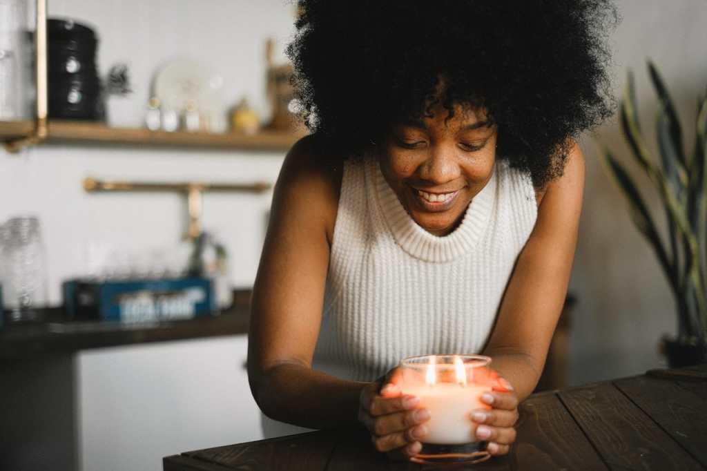 Black woman lighting a candle