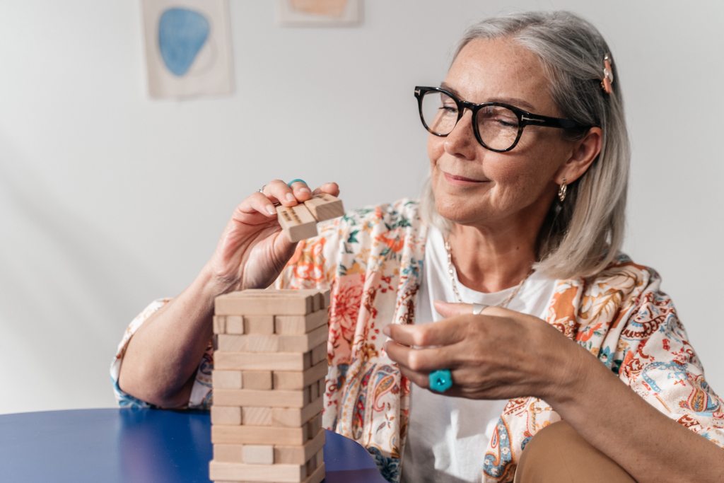 woman playing jenga wooden block game