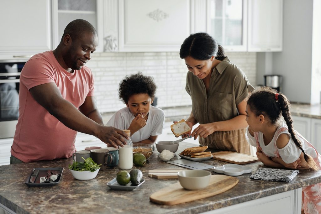 Family preparing breakfast together in the kitchen