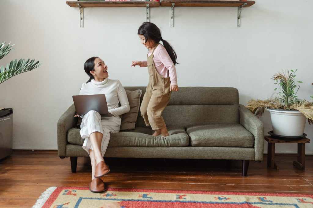 Mum working at home while havin fun with kid